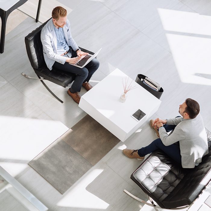 Business meeting in lobby by two businessmen